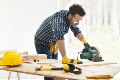 Man-using-saw-for-home-improvement-project-paid-for-by-a-HELOC.
