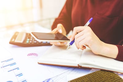 business-woman-works-home-remote-work-home-with-laptop-with-notebook-takes-notes-phone