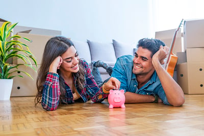 smiling-couple-with-piggybank-new-home