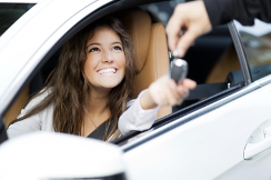 girl receiving keys to new car